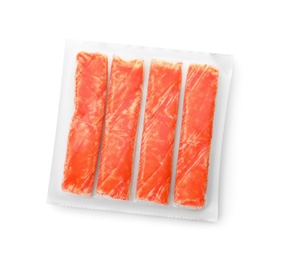 Photo of Delicious crab sticks in plastic packaging isolated on white, top view