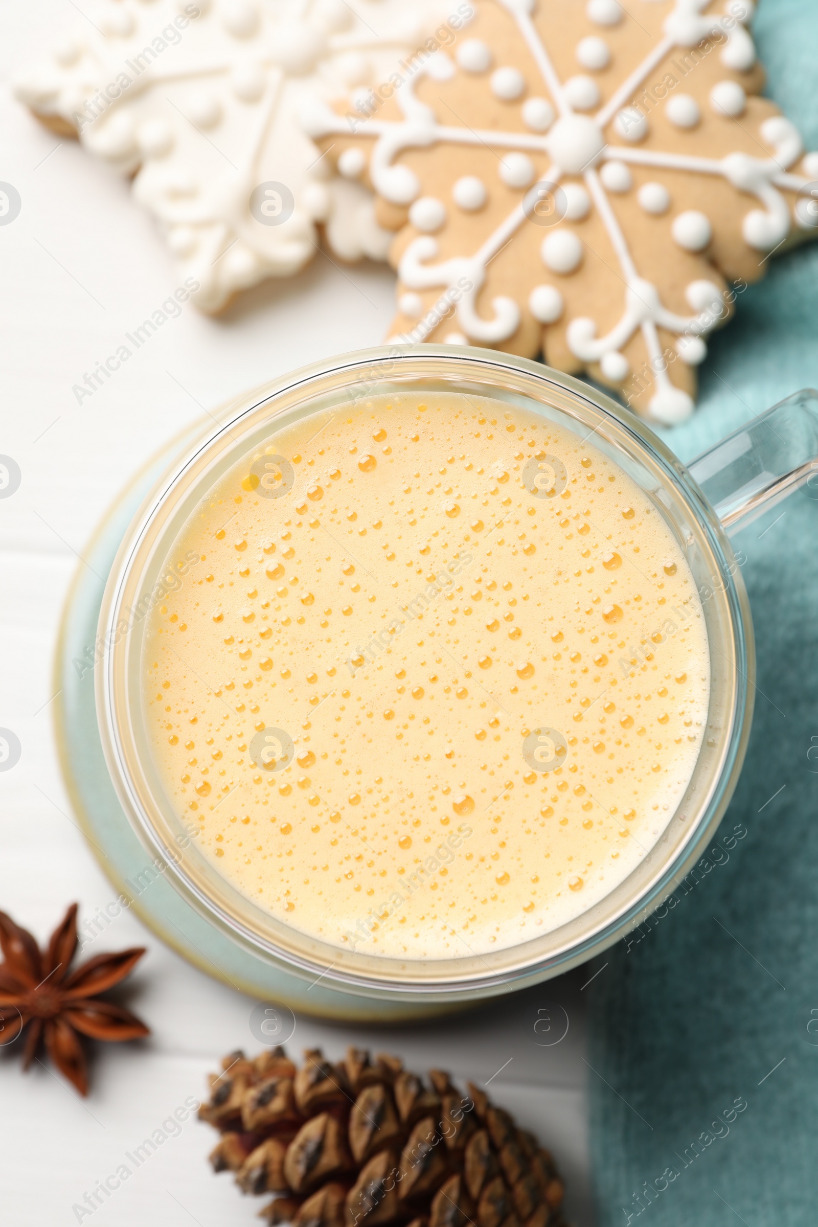 Photo of Tasty eggnog, cookies and anise star on white wooden table, flat lay