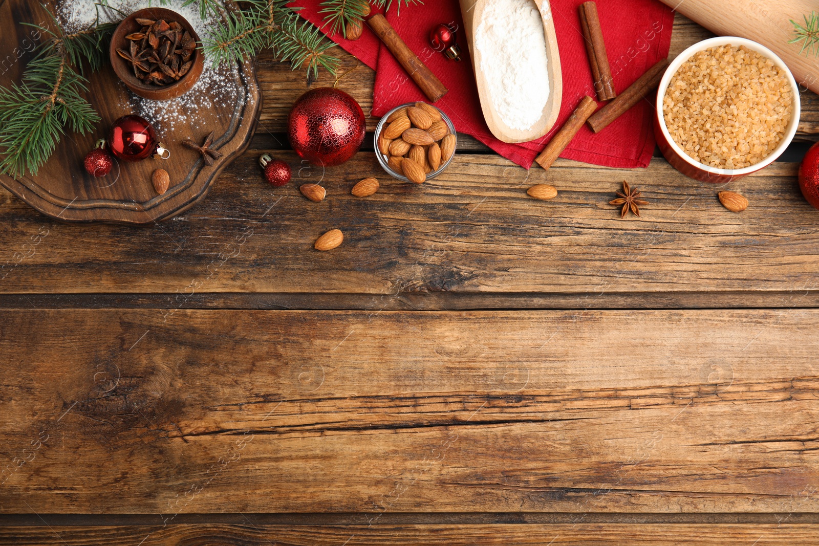 Photo of Flat lay composition with ingredients for traditional Christmas cake on wooden table. Space for text