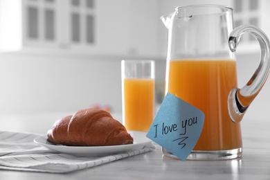 Romantic breakfast with note saying I Love You on table in kitchen