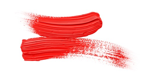 Photo of Red oil paint strokes on white background, top view