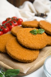 Photo of Delicious fried breaded cutlets served on white table, closeup