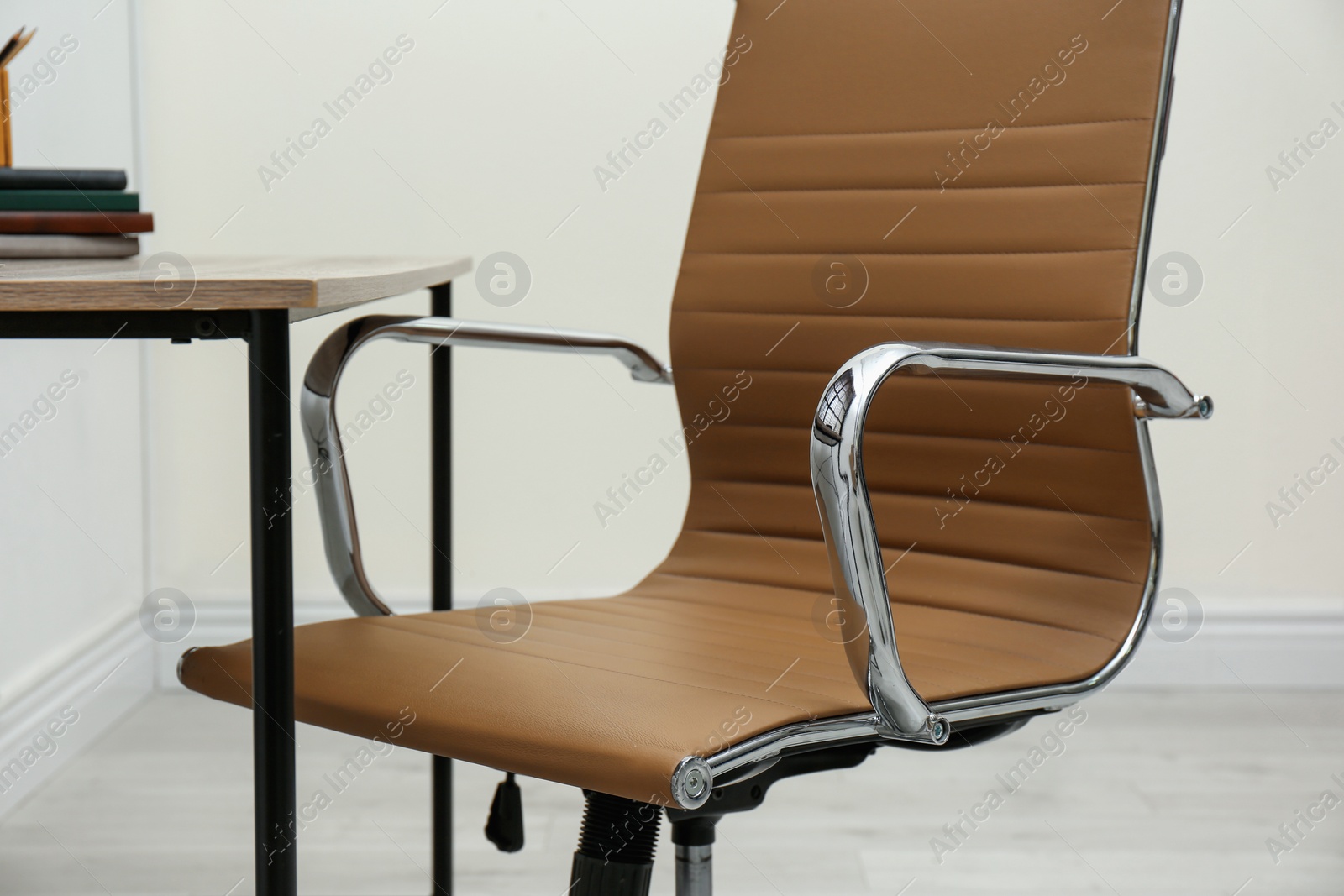 Photo of Modern office chair in stylish workplace interior