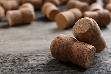 Sparkling wine bottle corks on wooden table, closeup. Space for text