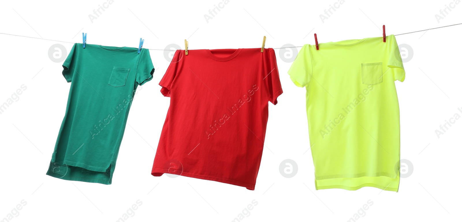 Photo of Colorful t-shirts drying on washing line isolated on white