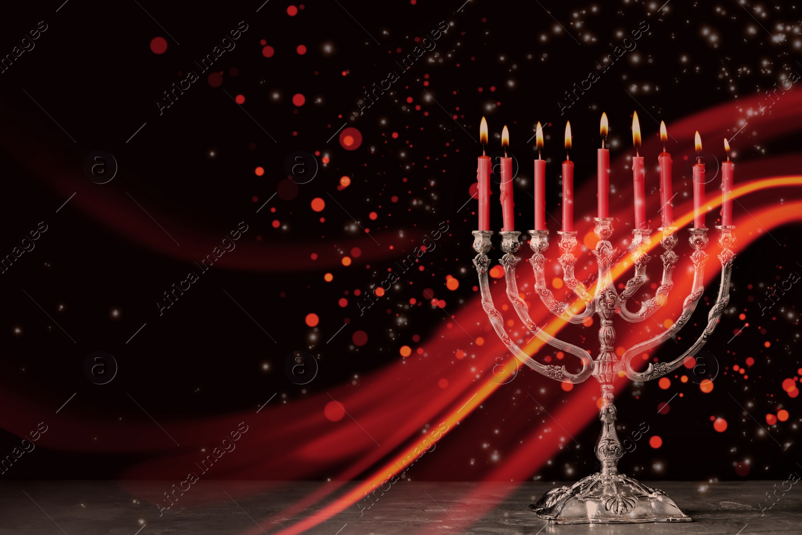 Image of Silver menorah with burning candles on table against black background, space for text. Hanukkah celebration