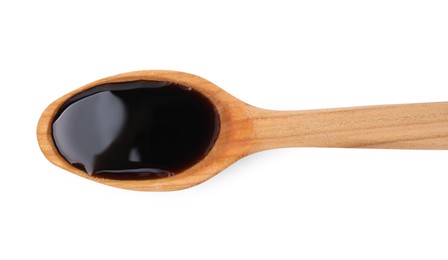 Wooden spoon with delicious caramel syrup isolated on white, top view