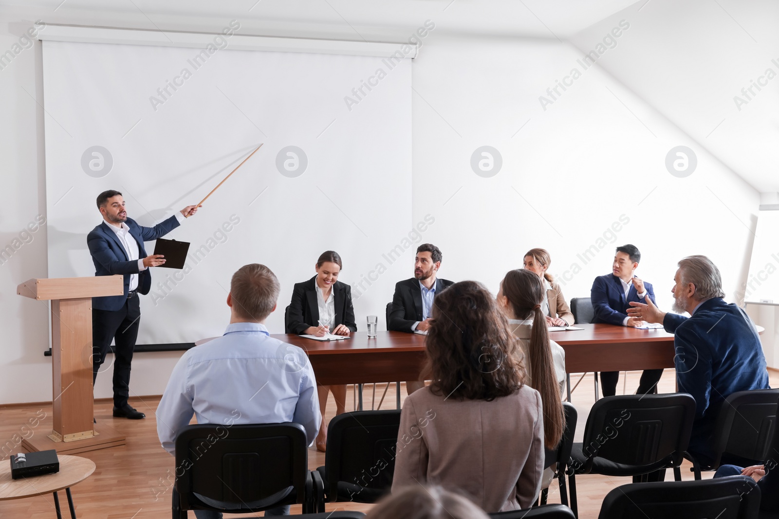 Photo of Business conference. People in meeting room listening to speaker report