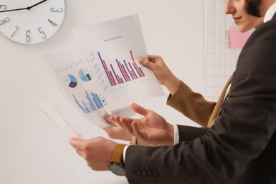 Photo of Businesspeople working with charts in office, closeup
