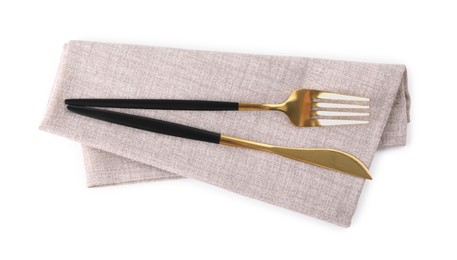 Photo of Grey napkin with golden fork and knife isolated on white, top view. Cutlery set