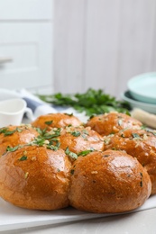 Photo of Traditional Ukrainian garlic bread (Pampushky) on table, closeup