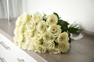 Luxury bouquet of fresh roses on commode