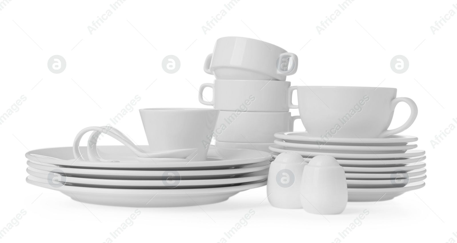 Photo of Set of clean dishware isolated on white