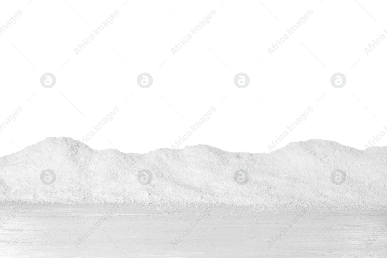 Photo of Heap of snow on wooden surface against white background