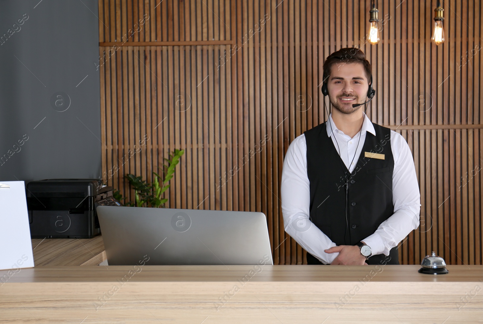 Photo of Portrait of receptionist with headset at desk in lobby