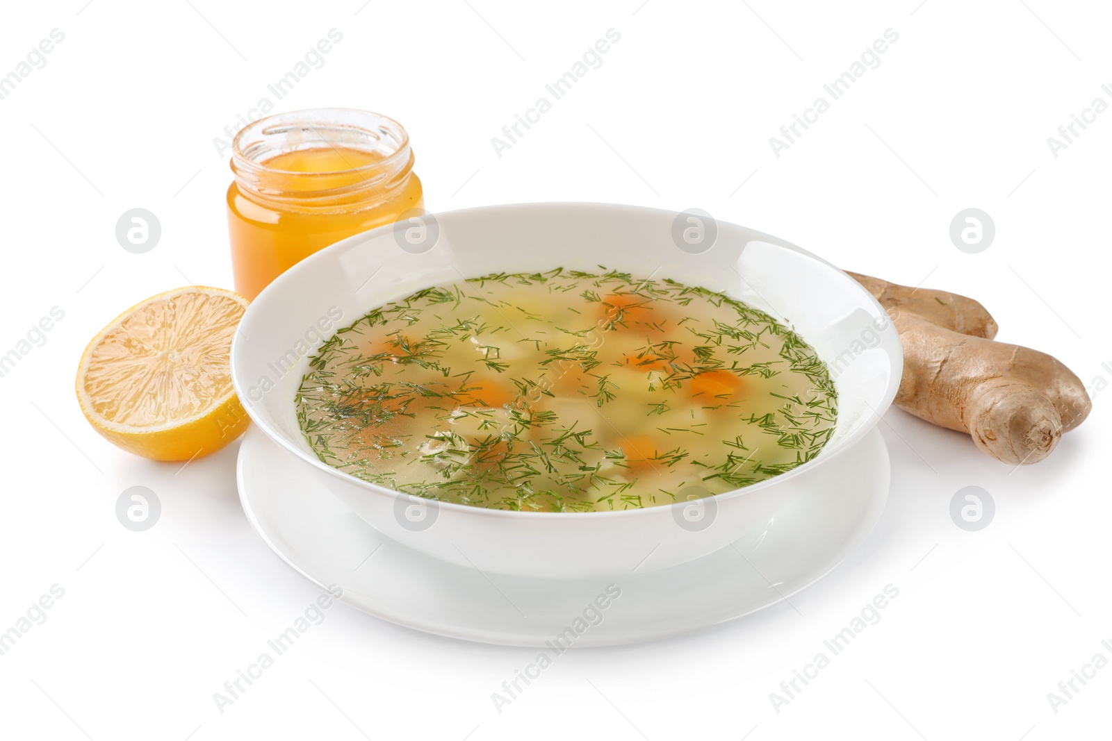 Photo of Bowl of fresh homemade soup to cure flu, lemon, ginger and honey on white background