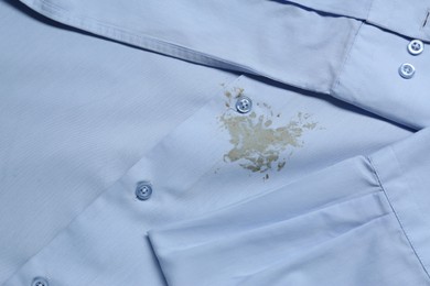 Photo of Closeup view of light blue shirt with stain