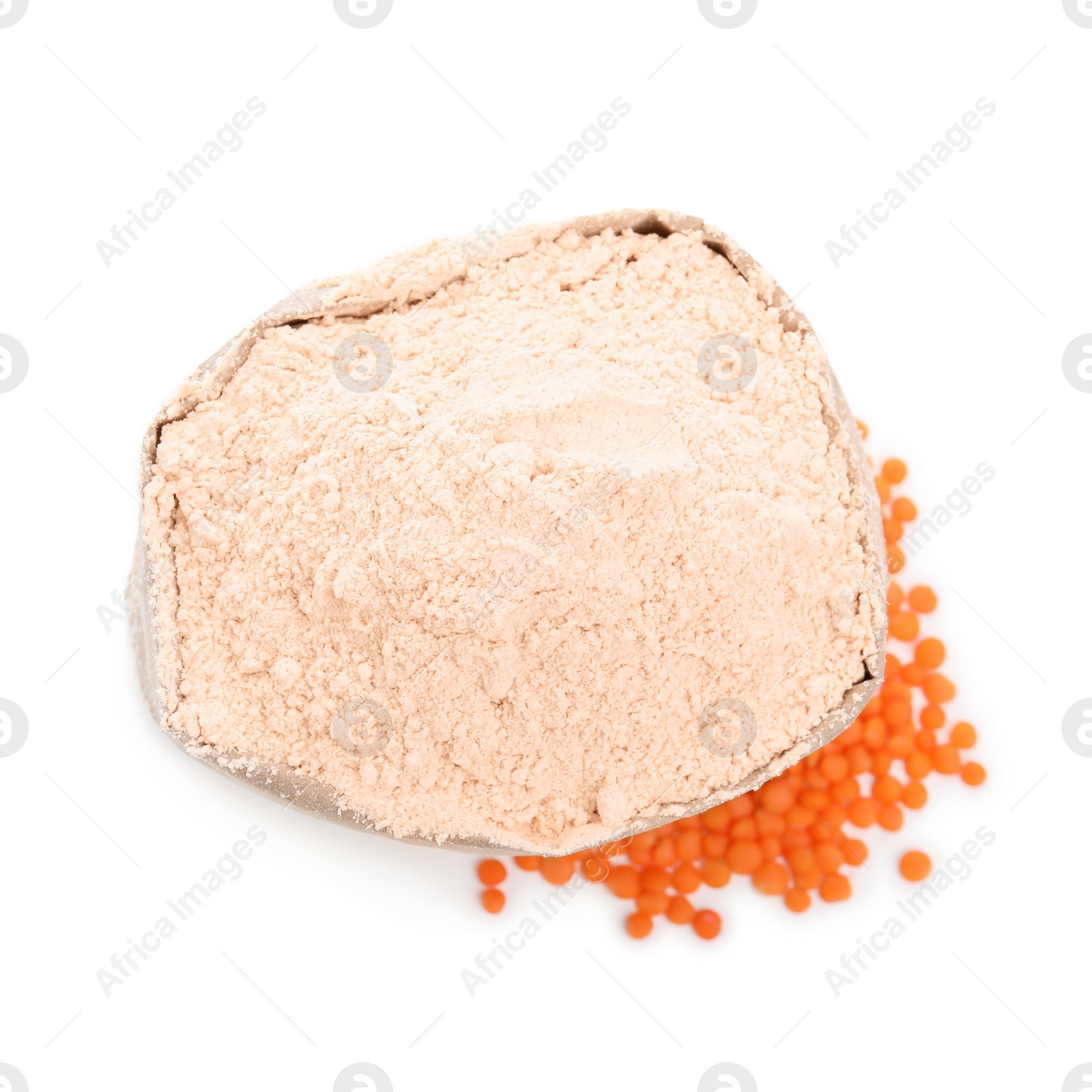 Photo of Paper bag with lentil flour and grains on white background, top view