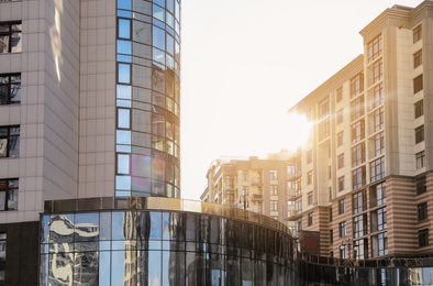 Modern buildings with tinted windows against sky. Urban architecture