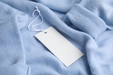 Warm light blue cashmere sweater with tag, closeup
