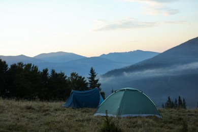 Photo of Camping tents in mountains on early morning