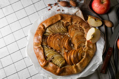 Delicious apple galette with pecans on table, flat lay
