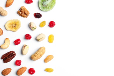 Flat lay composition of different dried fruits and nuts on white background. Space for text