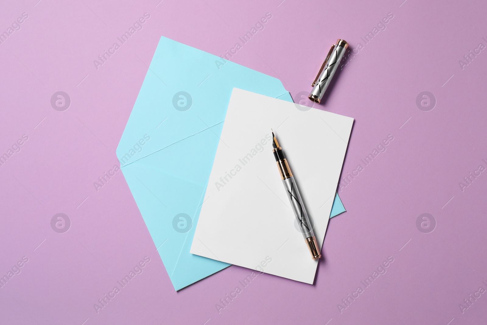 Photo of Blank sheet of paper, letter envelope and pen on violet background, top view