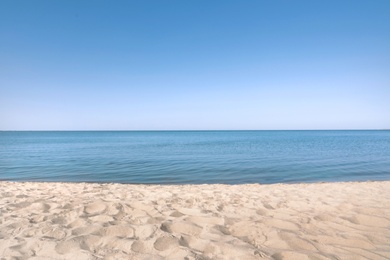 Photo of Sandy beach near sea on sunny summer day