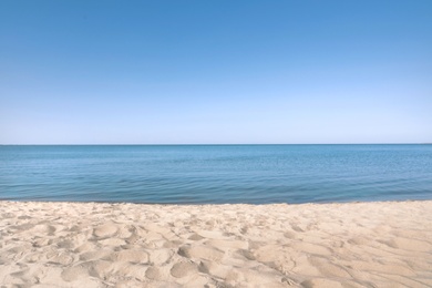 Sandy beach near sea on sunny summer day