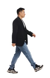 Photo of Handsome man in casual outfit walking on white background