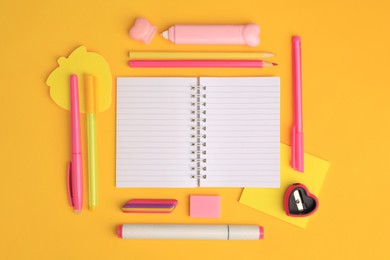 Photo of Flat lay composition with open notebook and different school stationery on yellow background, space for text. Back to school