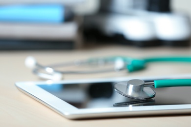 Stethoscope and tablet on table, closeup. Medical students stuff