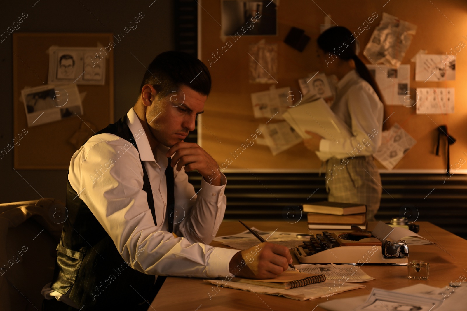 Photo of Old fashioned detective and his colleague working in office