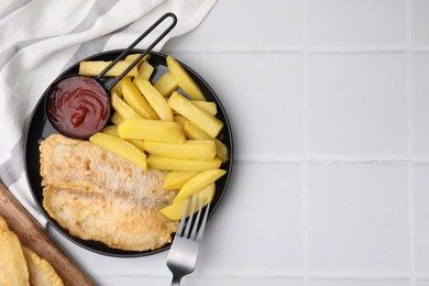 Photo of Delicious fish and chips served on white tiled table, flat lay. Space for text