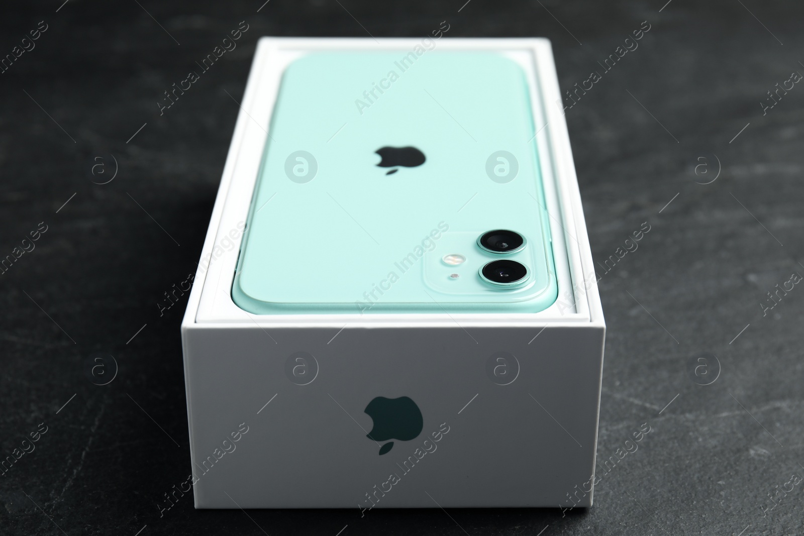 Photo of MYKOLAIV, UKRAINE - JULY 10, 2020: New modern Iphone 11 Green in original box on grey table