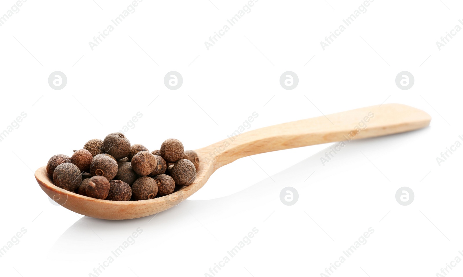 Photo of Wooden spoon with allspice pepper grains on white background