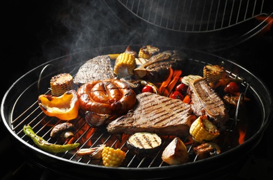 Photo of Assorted delicious meat and vegetables on barbecue grill