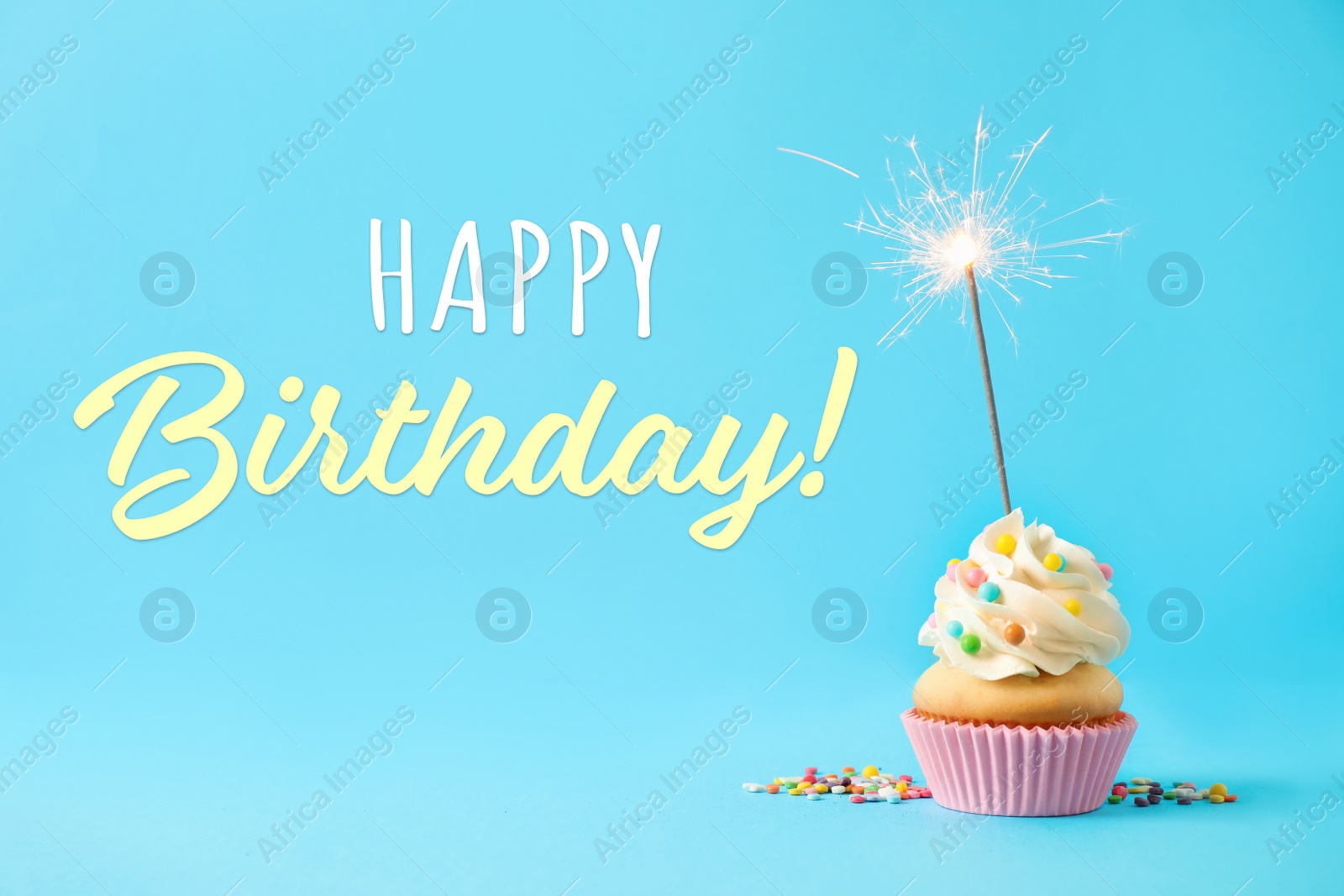 Image of Happy Birthday! Delicious cupcake with sparkler on light blue background