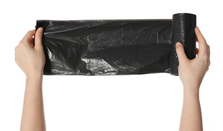 Woman holding roll of black garbage bags on white background, closeup