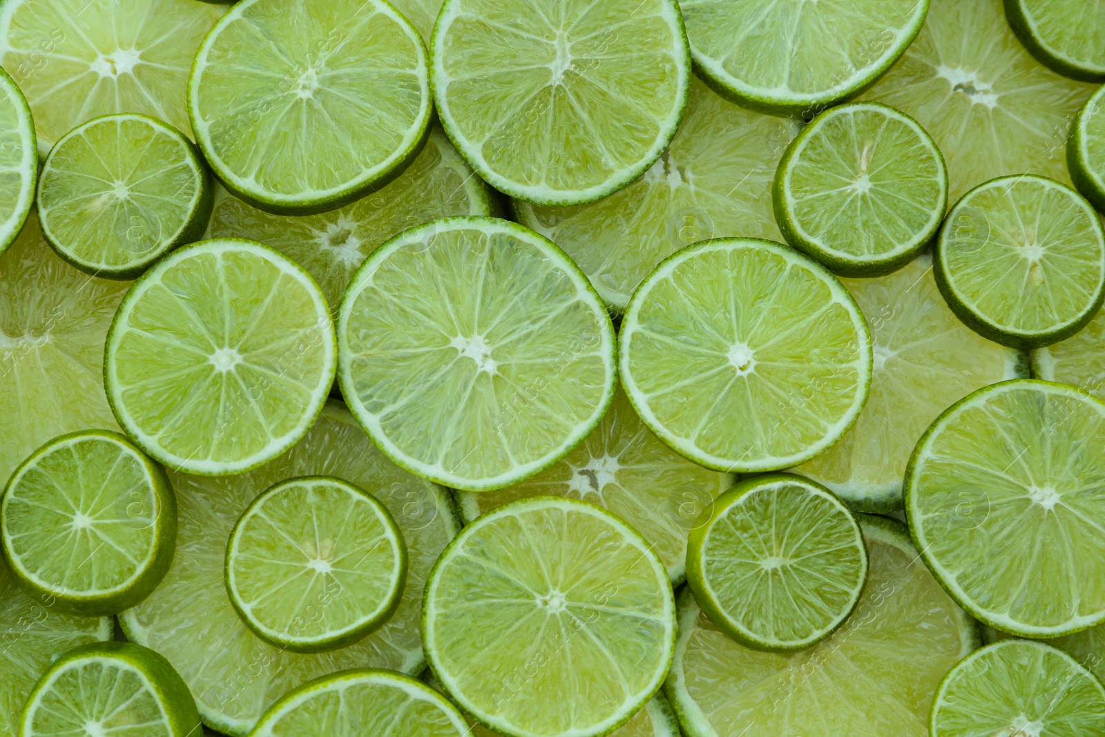 Photo of Fresh lime slices as background, top view