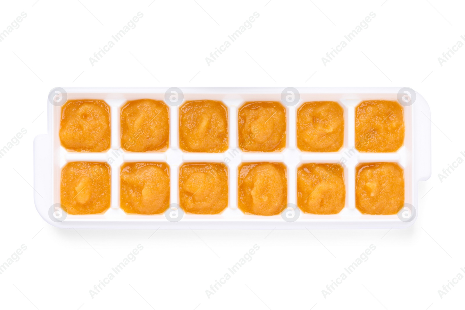 Photo of Nectarine puree in ice cube tray isolated on white, top view. Ready for freezing