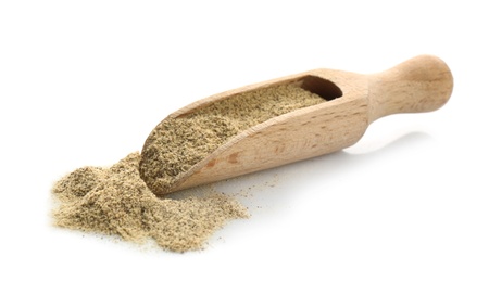 Wooden scoop with pepper powder on white background