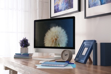 Photo of Modern workplace interior with computer on table