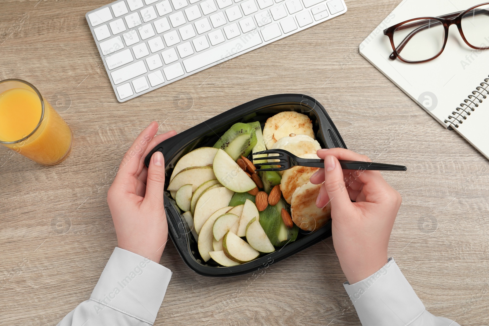 Photo of Office employee having business lunch at workplace, top view