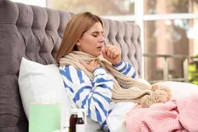 Photo of Woman suffering from cough and cold in bed at home