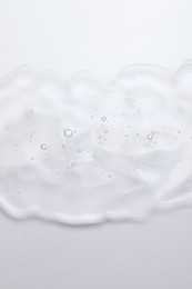 Photo of Sample of cosmetic oil on white background, top view