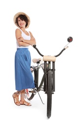 Portrait of beautiful young woman with bicycle on white background