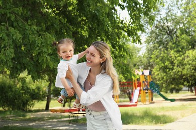 Photo of Happy mother with her daughter having fun in park