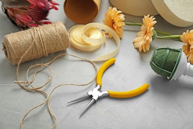 Photo of Florist equipment with flowers on table